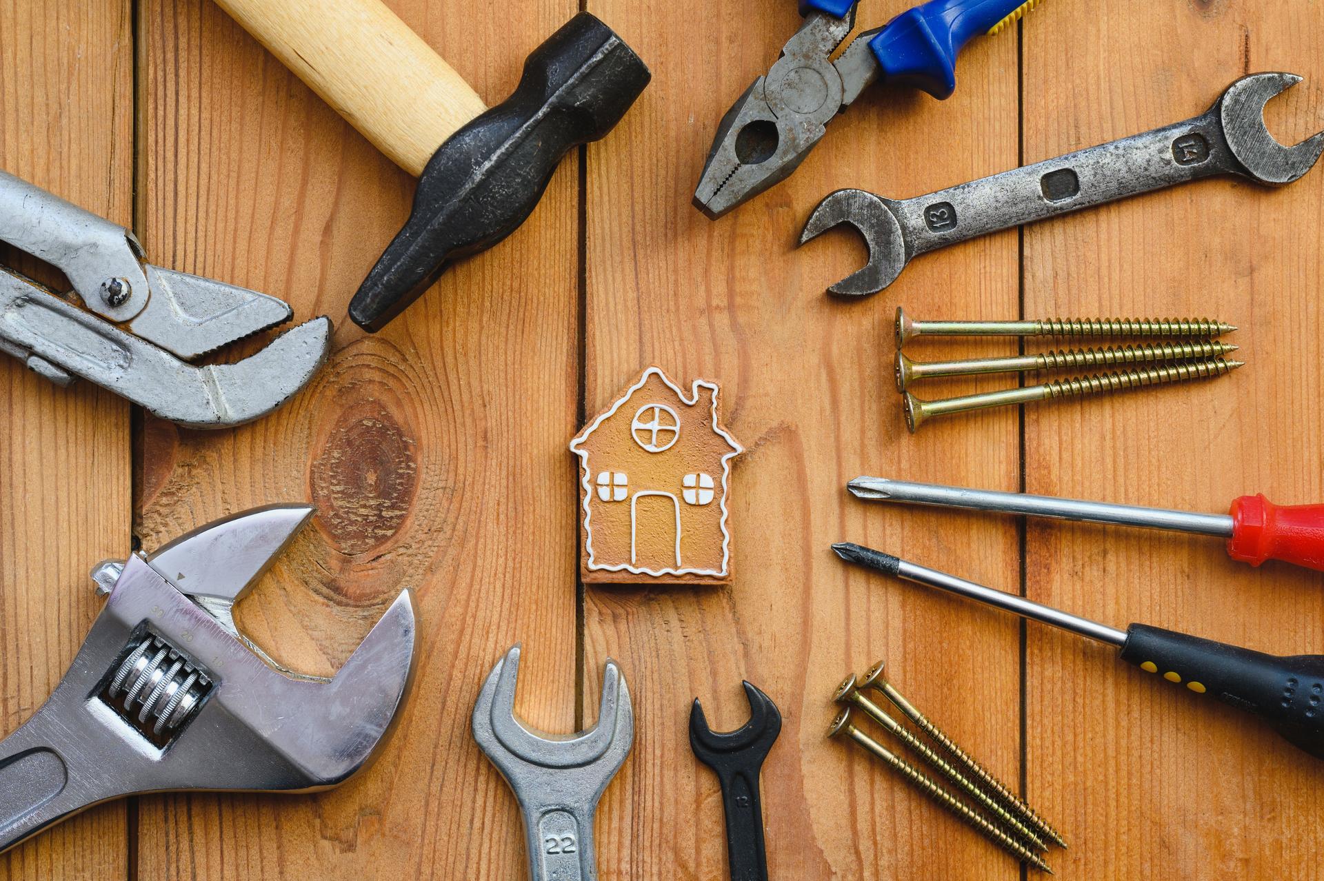 Many tools lie around a small house-shaped cookie.